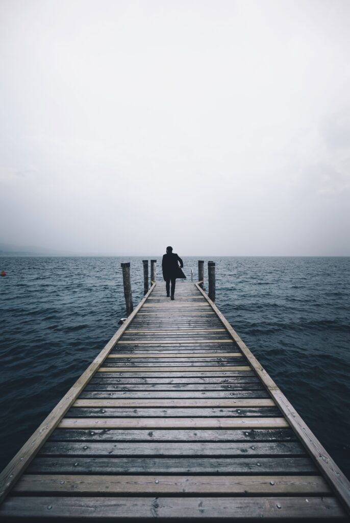 Man Walking on a Pier