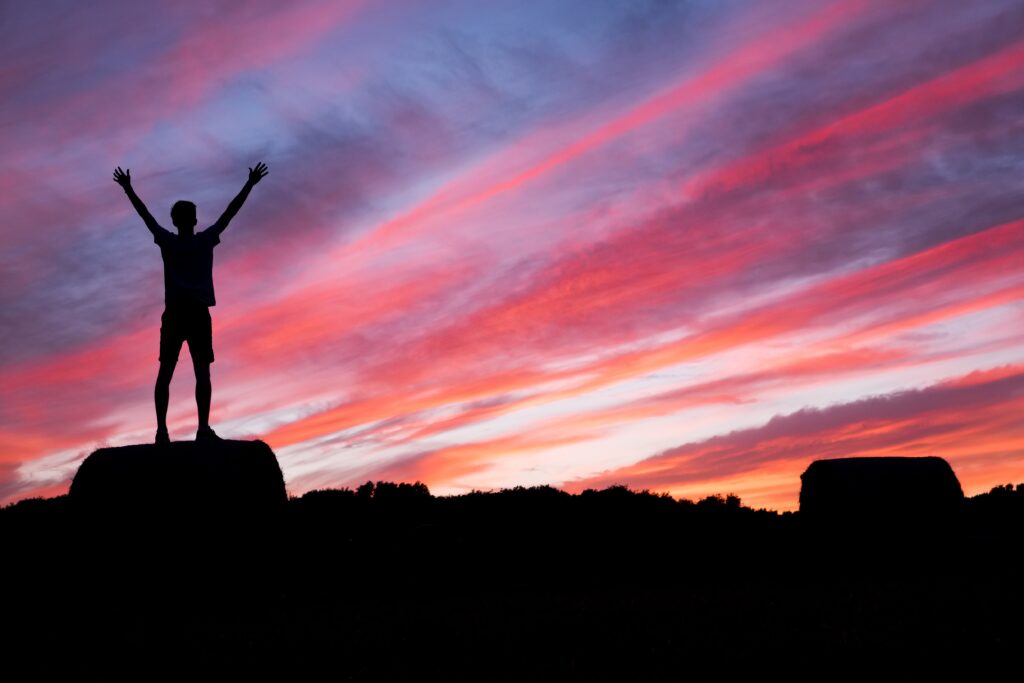 Silhouette of Man Raising Arms at Sunrise:Sunset