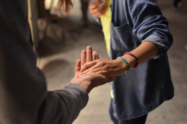Trust in the workplace requires true vulnerability, the same level of vulnerability necessary to put your hand in someone else's, even for a handshake, as in this picture.