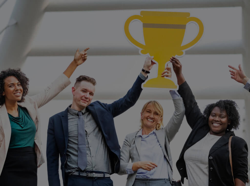 A solid performance management process leads to improved results and happier employees, just like the employees pictured here celebrating a win.